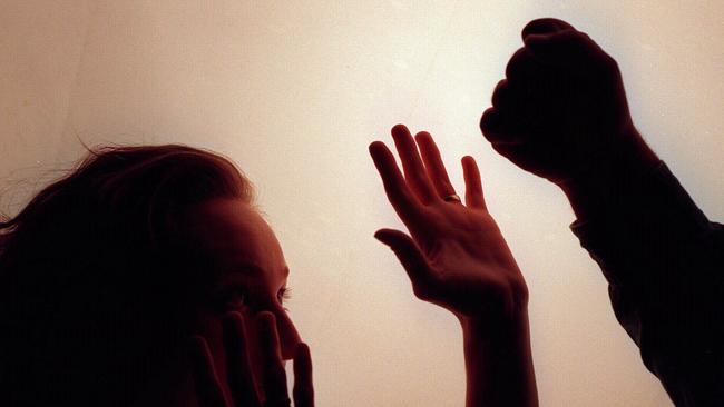 Domestic violence silhouette generic image - fist raised against woman./Violence