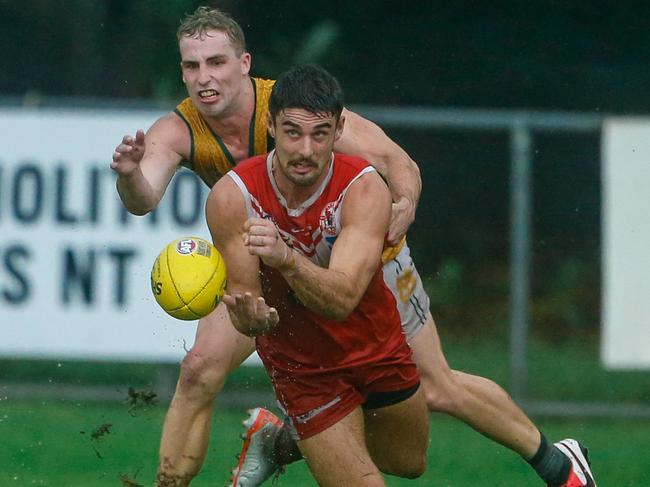 Robert Turnbull gets the ball away from Dylan Landt in Round 16 NTFL Men's Premiership League. Picture: Glenn Campbell