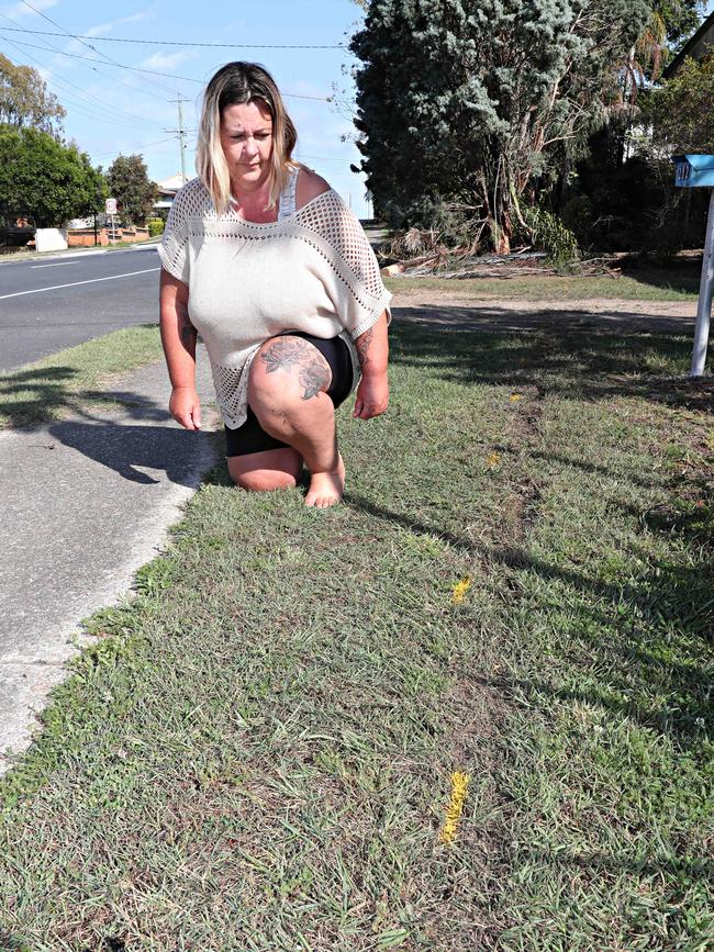 Lisa Livingstone in front of skid marks left on the lawn after a car crashed on to a Bray Park property. Picture: Annette Dew