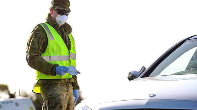 An Australian soldier assists police at a vehicle checkpoint on the Princes Hwy at Little River near Geelong. Picture: NCA NewsWire / Ian Currie