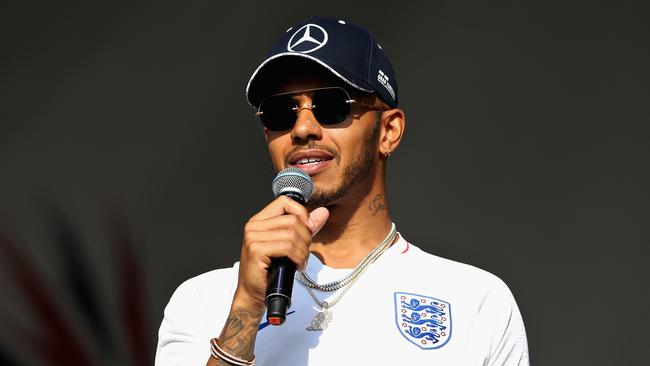 NORTHAMPTON, ENGLAND - JULY 07: Lewis Hamilton of Great Britain and Mercedes GP talks to fans on the Fan Stage after qualifying for the Formula One Grand Prix of Great Britain at Silverstone on July 7, 2018 in Northampton, England. (Photo by Charles Coates/Getty Images)