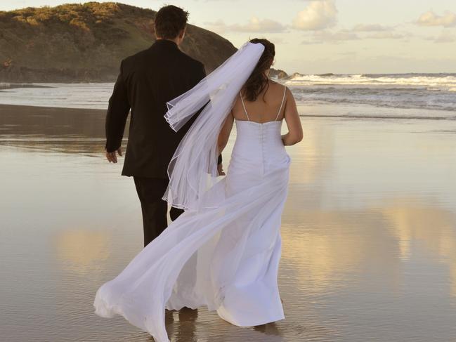 Generic image of bride and groom on a beach. From iStock.