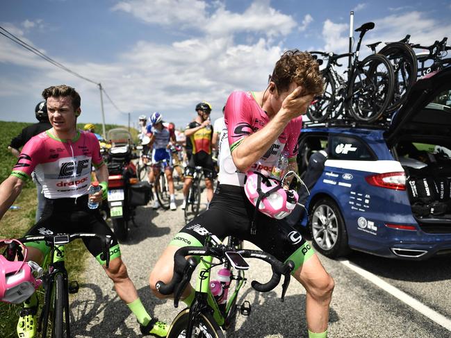 Riders clean their eyes after tear gas was used during a farmers' protest.