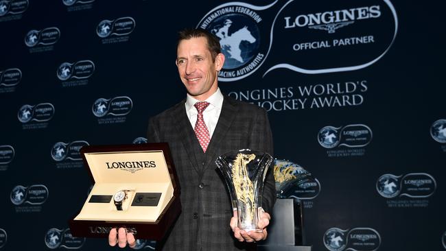 Australian jockey Hugh Bowman poses with trophy and watch after being awarded 2017 Longines World's Best Jockey Award. Picture: Vince Caligiuri, Getty Images.