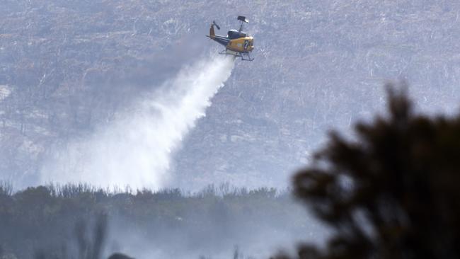 A helicopter drops water on spot fires in the Central Highlands. PICTURE CHRIS KIDD