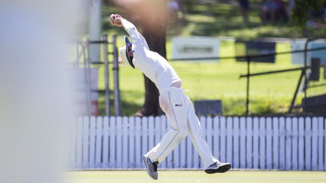 Off the ground, hands behind him, Michael Philipson snares a great catch.(AAP Image/Renae Droop)