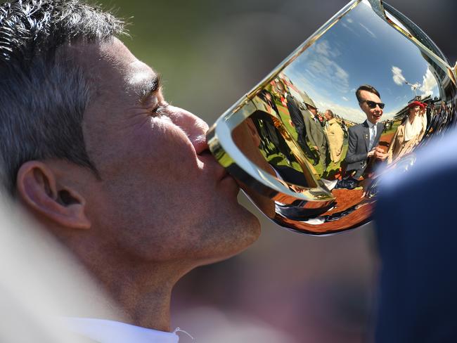 Jockey Corey Brown kisses the Melbourne Cup trophy. Picture: AAP