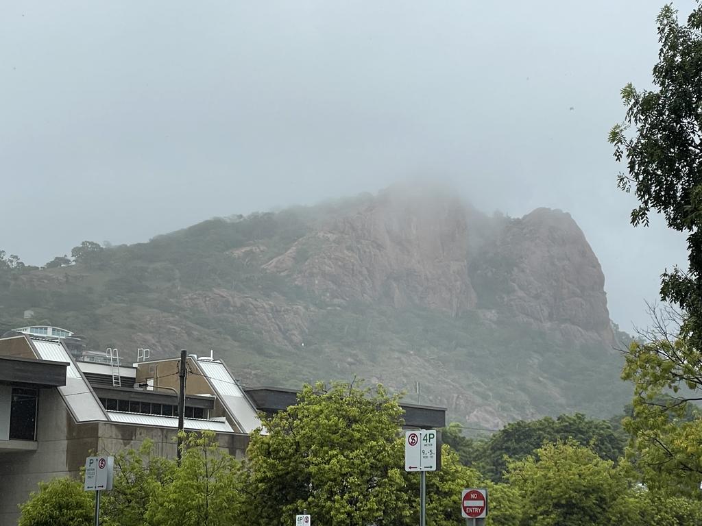 Cloud shrous Castle Hill as the rain sweeps into Townsville on New Year's Day. Picture: Leighton Smith.