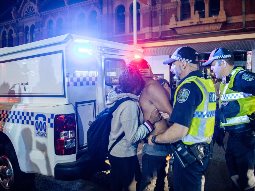 A man is consoled as he’s taken away by police in Hindley St in the early hours of 2020. Picture: AAP / Morgan Sette