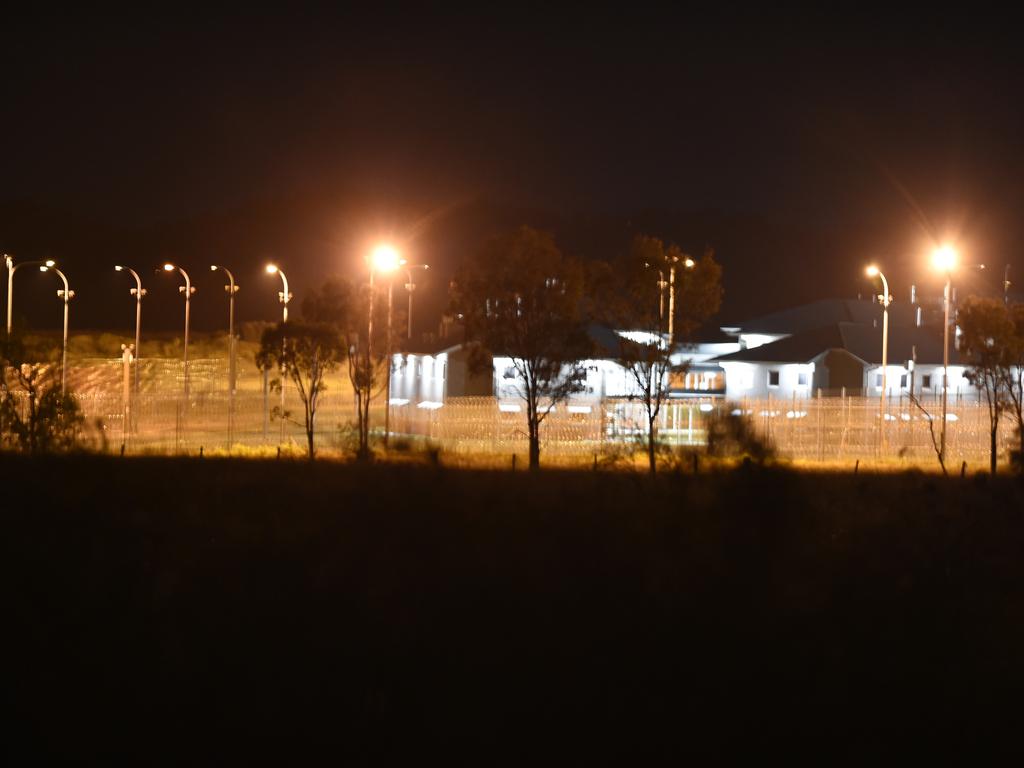 Police vehicles at the perimeter of the Capricornia Correctional Centre late on Thursday night during the riots and protests.