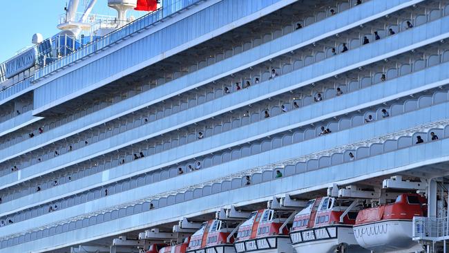 Crew members dot the balconies of the Ruby Princess to take in the views of Port Kembla, NSW, on Monday as the ship refuels. Picture: AAP