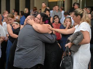 Lisa Harwick is consoled after the memorial service for her husband Brad Hardwick. Picture: Zizi Averill