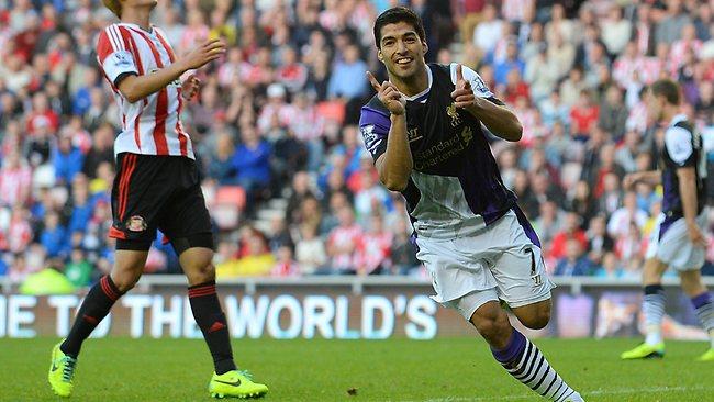 Liverpool's Uruguayan striker Luis Suarez  celebrates scoring his team's third goal