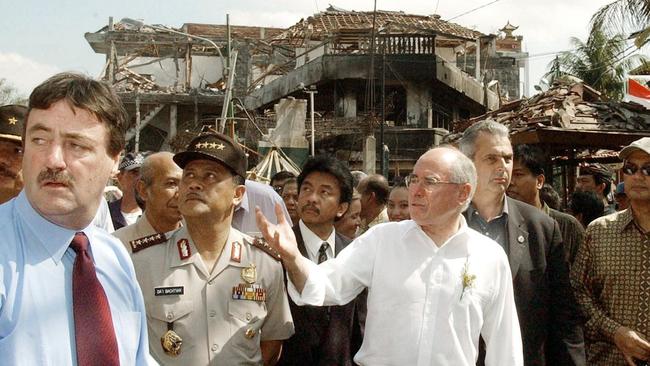 Then Australian prime minister John Howard (centre) tours the site of the October 12, 2002, bombings in Kuta, Bali, with Australian Federal Police Commissioner Mick Keelty (left) and Indonesian National Police Chief, General Da'i Bachtiar. Picture: AFP/Dean Lewins