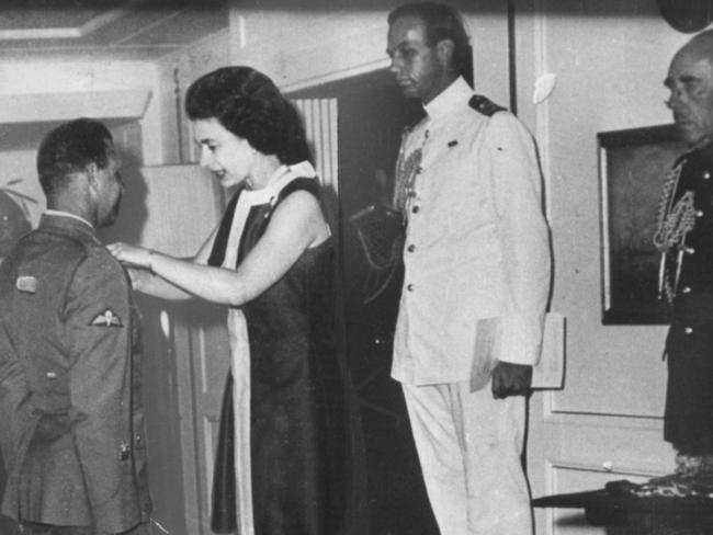 Keith Payne is awarded the Victoria Cross (VC) by Queen Elizabeth II during a ceremony on-board the Royal Yacht 'Britannia' in Brisbane, April 15, 1969.