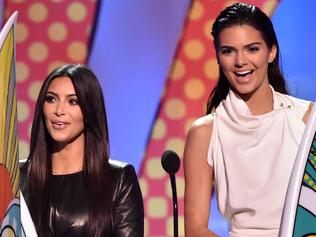 LOS ANGELES, CA - AUGUST 10: (L-R) TV personalities Kylie Jenner, Kim Kardashian, and Kendall Jenner onstage during FOX's 2014 Teen Choice Awards at The Shrine Auditorium on August 10, 2014 in Los Angeles, California. (Photo by Kevin Winter/Getty Images)