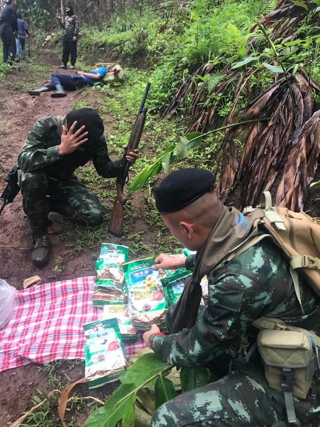 Phamuang discover ice smuggled in green tea packets. The smuggler's corpse lies in the background. Picture: Conor Woodman