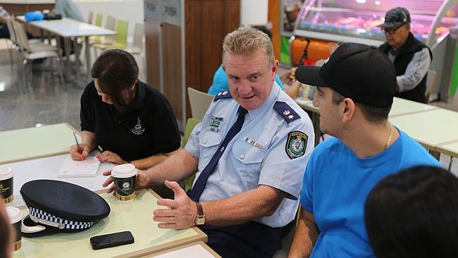 Fairfield police Supt Peter Lennon chats to residents Eleni Voniatis and Loukas Voniatis about local issues.