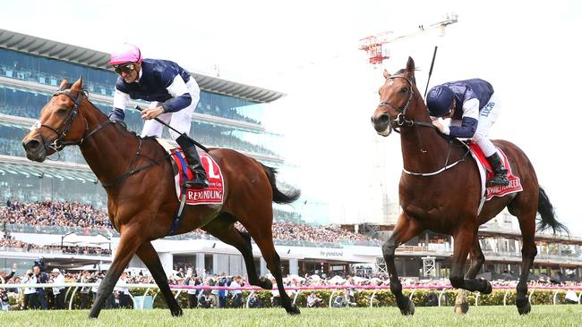 Corey Brown rides Rekindling, left, to win the Melbourne Cup ahead of Johannes Vermeer