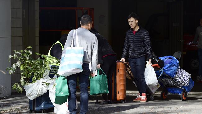 Residents carry their personal items out of the Mascot Towers last week.