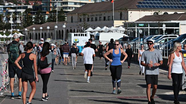 People walking along Bondi Beach foreshore on Sunday.