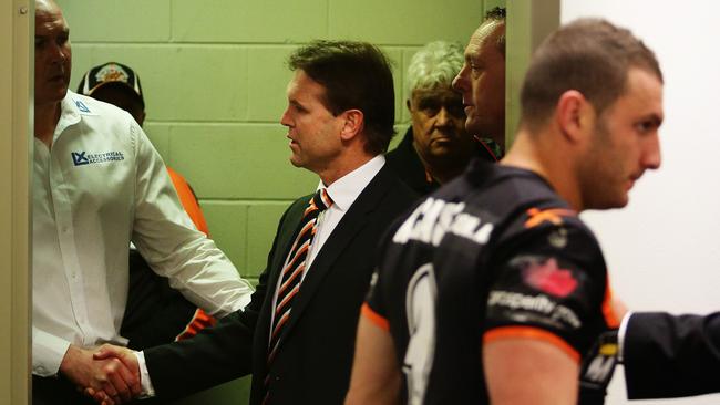 Wests Tigers coach Mick Potter enters the press conference room with Robbie Farah.