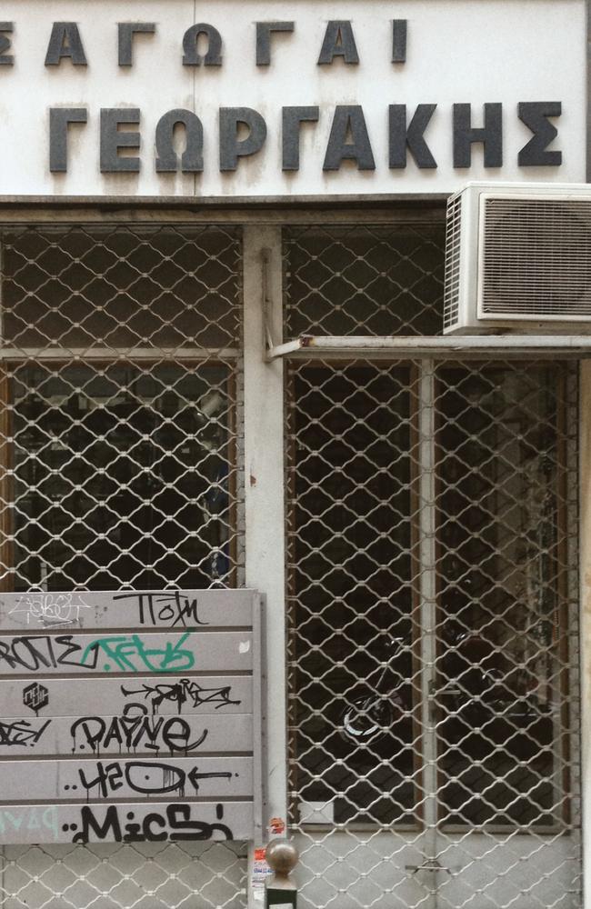 A closed down shop in Athens city centre. The sign reads "Imports — Gerasimos Georgakis".