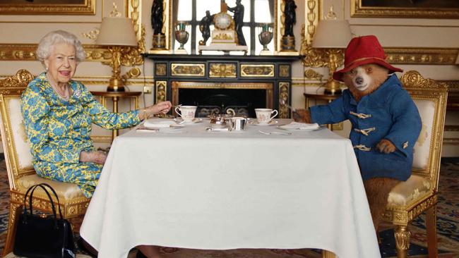 Queen Elizabeth II and Paddington Bear having cream tea at Buckingham Palace, taken from a film that was shown at the BBC Platinum Party at the Palace. Picture: AFP