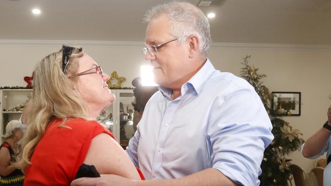 Prime Minister Scott Morrison hugs Helen Glanville while visiting the relief centre in Lobethal, South Australia. Picture: AAP