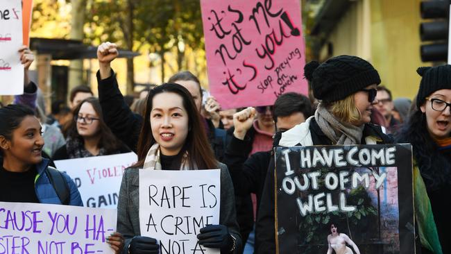 Protesters holding placards march along Swanston Street in Melbourne, Saturday, June 22, 2019. A similar protest will be held on Monday in Toowoomba. (AAP Image/James Ross) NO ARCHIVING