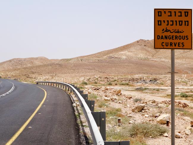 Roadside warning sign "dangerous curves" near the Dead Sea, Israel