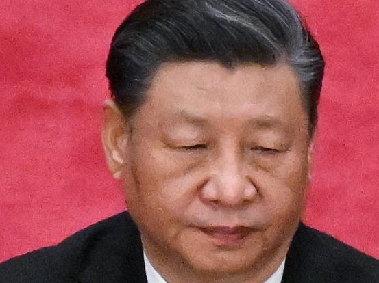 China's President Xi Jinping applauds during the opening session of the National People's Congress (NPC) at the Great Hall of the People in Beijing on March 5, 2023. (Photo by NOEL CELIS / AFP)