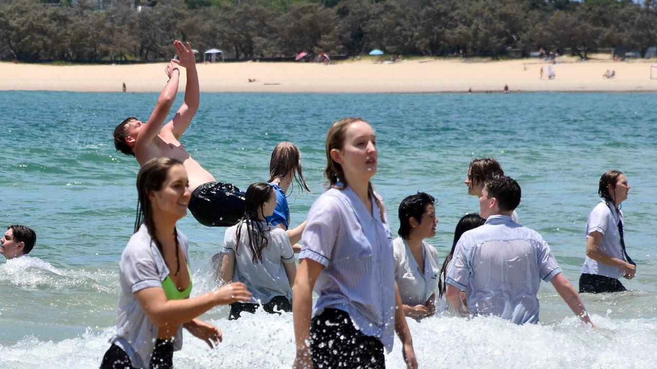 Year 12 graduates from schools across the Sunshine Coast hit to the water at Mooloolaba Beach to celebrate the end of their schooling. Photo: Mark Furler