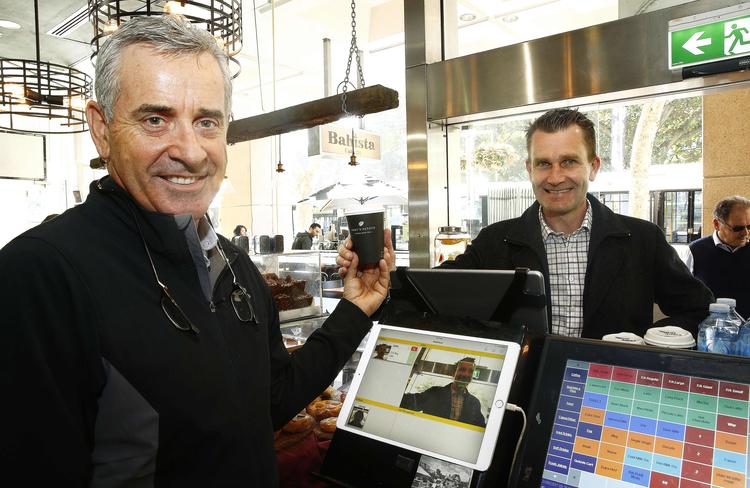 Cafe owner Geoff Cropley and software coder John McLean with the facial recognition technology. Pictures: John Appleyard