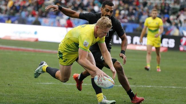 HIGHLIGHT GOLD: Two years ago Lachie Miller was playing both league and union on the Coffs Coast. Now the St John Paul College product is blitzing the HSBC World Sevens Series. Here he scores a try in front of New Zealand's Amanaki Nicole in the third play-off at the Los Angeles Sevens on Sunday.     . Picture: Ringo H.W. Chiu