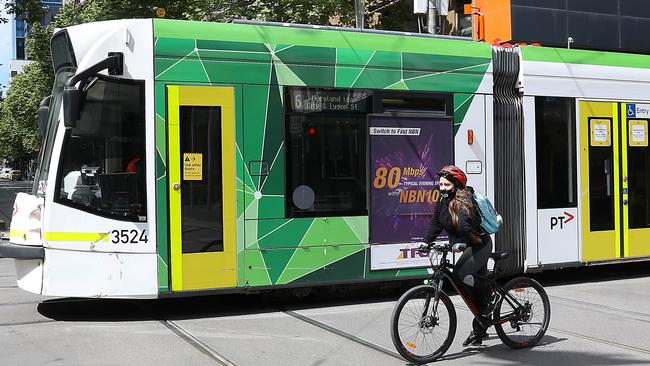 A cyclist and tram head north up Swanston Street. Picture: NCA NewsWire / Ian Currie