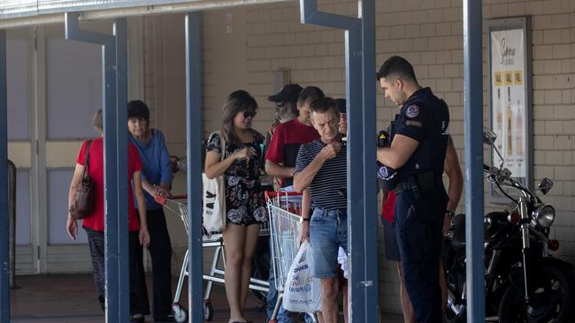 Police check identification in Alice Springs on Saturday night. Picture: Liam Mendes / The Australian