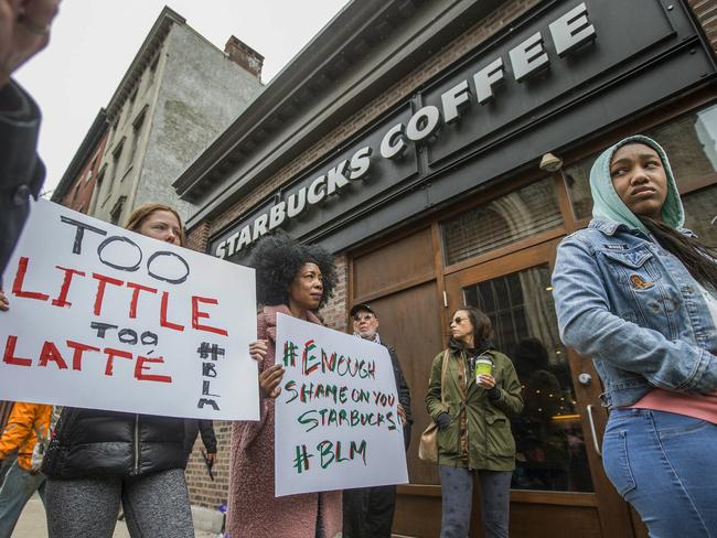 Protesters gather outside of a Starbucks in Philadelphia, where two black men were arrested after employees called police to say the men were trespassing. The arrest prompted accusations of racism on social media. Picture: Michael Bryant/The Philadelphia Inquirer via AP