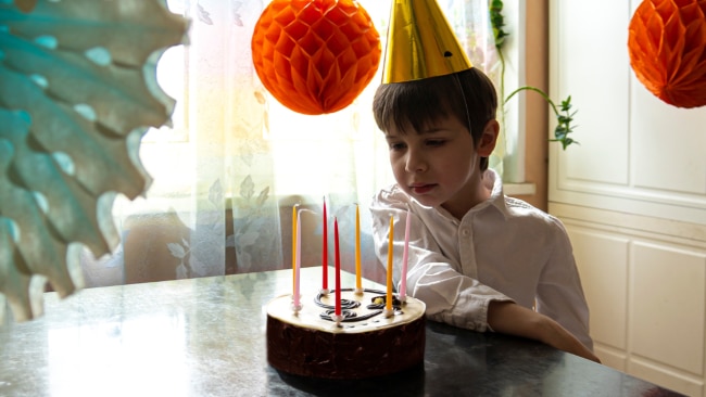 A mother "covers" for her son's absent father on his birthday. Source: iStock