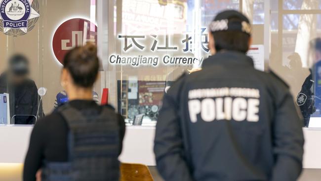 AFP officers executing a search warrant at Changjiang Currency Exchange in the Sydney CBD as part of Operation Avarus-Nightwolf.