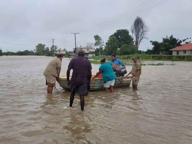 Burketown residents move belongings to higher ground.