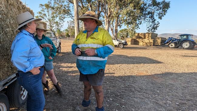 Ban Ban farmer Les Palmer, right, speaking with AgForce president Georgie Somerset while picking up emergency fodder. Picture: Stephanie Denman/DAF