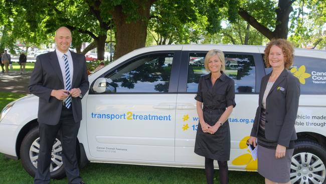 From left, Dry July ambassadors Brent Costelloe and Speaker Elise Archer and Cancer Council Tasmania CEO Penny Egan with the transport2treatment vehicle.