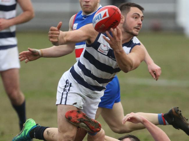 James Siakavallis dishes out a handball. Picture: Stuart Milligan