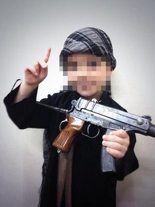 Sharrouf posted a photo of a young boy holding what appears to be an actual machine gun.