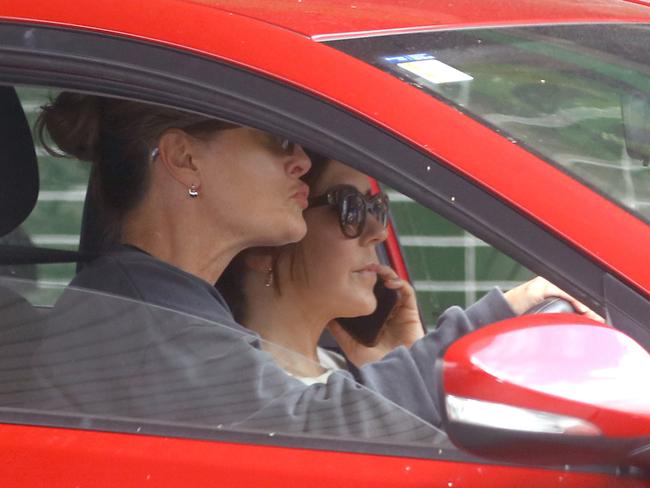 Princess Mary jumps on the phone as she drives around Melbourne on Thursday. Picture: Matrix