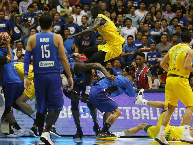 Thon Maker of the Boomers comes flying in to join the brawl. Picture: AP Photo