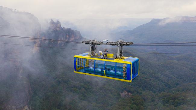 Sydney's Blue Mountains became the ultimate stage for Australian musician G Flip who performed their new track "The Worst Person Alive" atop a cable car 270m in the air. Picture: Paul Lojszczyk/Getty Images for DNSW