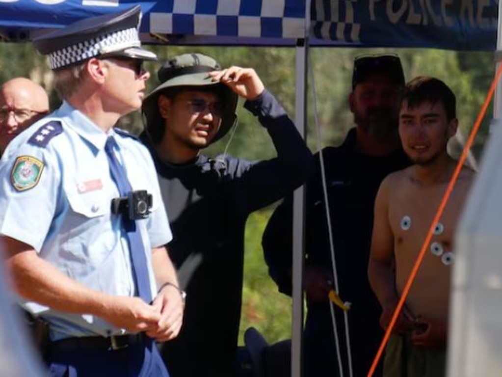 Hadi Nazari can be seen bare-chested after he was found alive in dense NSW bushland in the Kosciuszko National Park. Picture: ABC/Adriane Reardon