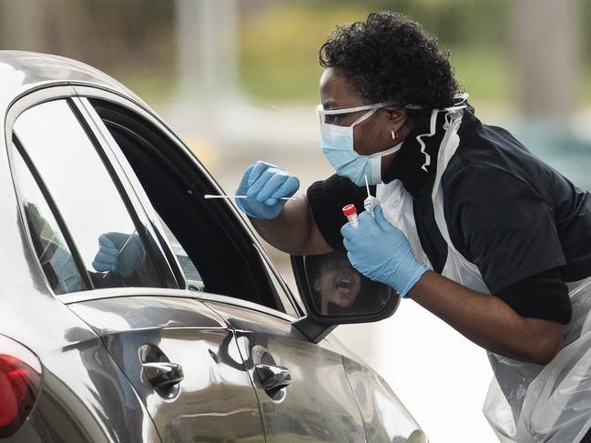 A nurse swabbing a motorist at a drive-through testing station in Chessington, United Kingdom. Picture: Dan Kitwood/Getty